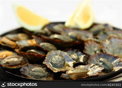 Grilled limpets with lemon. Madeira&rsquo;s traditional dish.