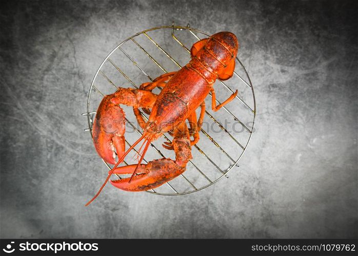 Grilled lobster on grill on the dark background / red lobster food on dining table , top view