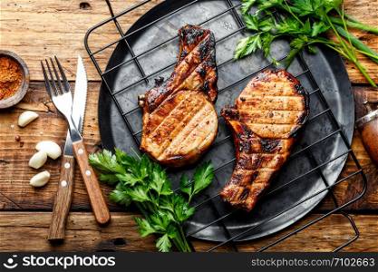 grilled meat, a portion of two pork loin steaks barbecue