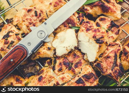 Grilled meat and knife for cooking