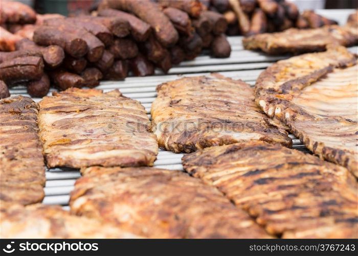 Grilled meat and sausages on a gridiron