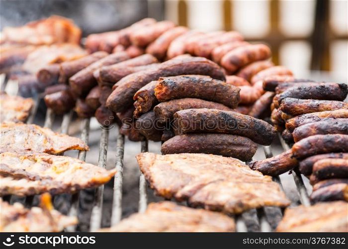 Grilled meat and sausages on a gridiron