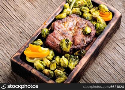 Grilled meat barbecue steak with brussels sprouts.Grilled meat and vegetable garnish. Meat steak with brussels sprouts