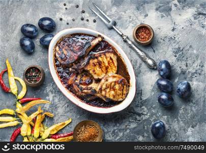 Grilled meat. Grilled meat with autumn plum.Bbq. Grilled meat in plum sauce