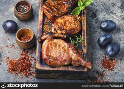 Grilled meat. Grilled meat with autumn plum.Bbq.Pork rack grilled. Pork ribs grilled