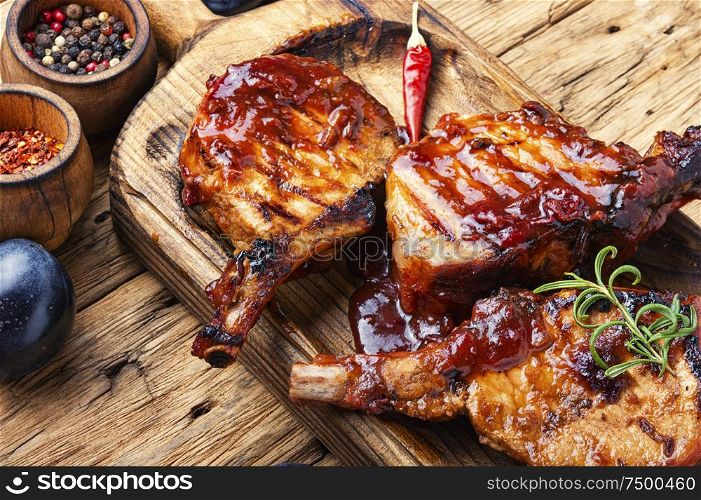 Grilled meat. Grilled meat with autumn plum.Bbq. Roasted sliced barbecue pork ribs