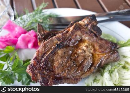 grilled meat in plate on wooden table