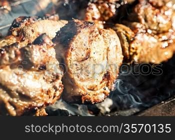 Grilled meat on barbecue. Shallow depth of field