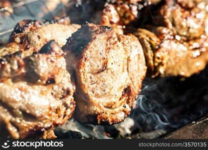 Grilled meat on barbecue. Shallow depth of field