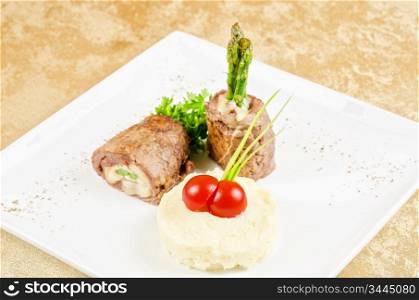 Grilled meat rolls from beef meat with mozzarella, ham, asparagus and mashed potatoes