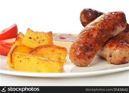 grilled meat sausages with potatoes and tomatoes