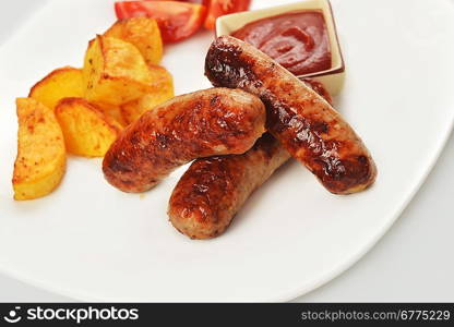 grilled meat sausages with potatoes and tomatoes