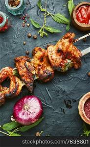 Grilled meat skewers or shish kebab pickled in nettle foliage. Shish kebab marinated in nettles