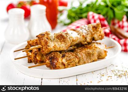 Grilled meat skewers, shish kebab on white background