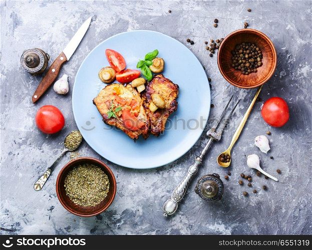 Grilled meat steak,tomato, herbs and spices on the plate.Bbq meat. Grilled fillet steak