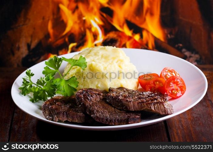 grilled meat with potatoes, tomatoes and herbs