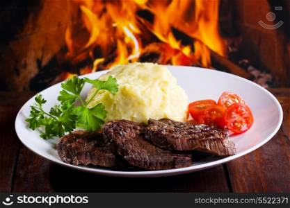 grilled meat with potatoes, tomatoes and herbs