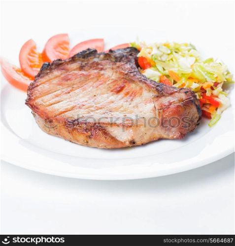 Grilled meat with spices on a white plate