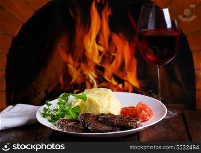 grilled meat with vegetables and glass of wine