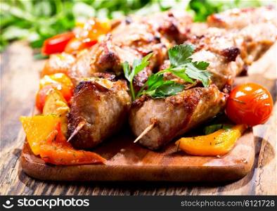 grilled meat with vegetables on wooden board