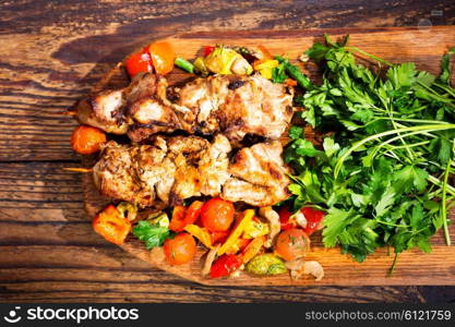 grilled meat with vegetables on wooden board