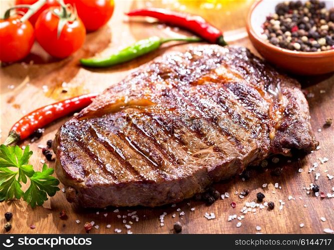 grilled meat with vegetables on wooden board