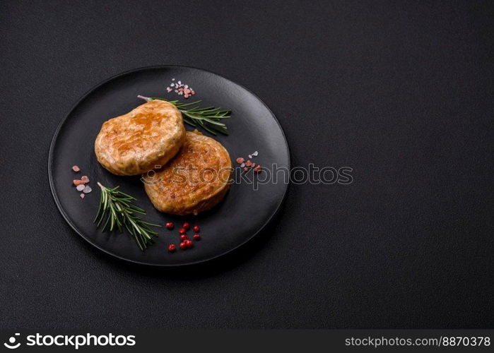 Grilled meatballs with spices and herbs or crepinette on a dark concrete background