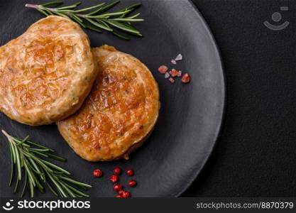 Grilled meatballs with spices and herbs or crepinette on a dark concrete background