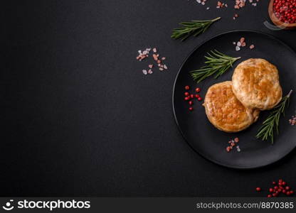 Grilled meatballs with spices and herbs or crepinette on a dark concrete background