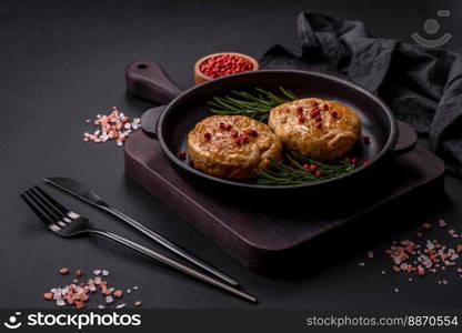 Grilled meatballs with spices and herbs or crepinette on a dark concrete background