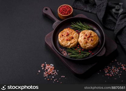 Grilled meatballs with spices and herbs or crepinette on a dark concrete background