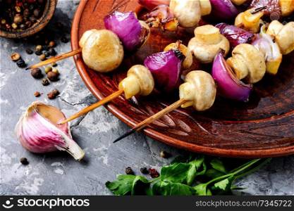 Grilled mushrooms on wooden skewers. Vegetable shish kebab.Roasted mushrooms. Delicious fried mushrooms