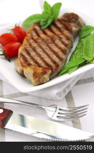 Grilled New York steak served on a plate with vegetables