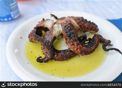 Grilled Octopus in sause on white dish