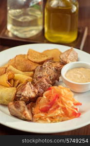 Grilled pork, baked potatoes and vegetable salad