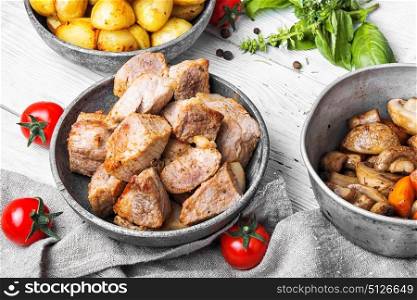 Grilled pork meat. Lunch with stew sliced of pork and boiled potatoes