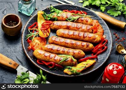 Grilled pork sausages on the plate.Fried sausages. Fried sausages and vegetables