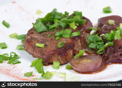 Grilled pork steak on white plate.