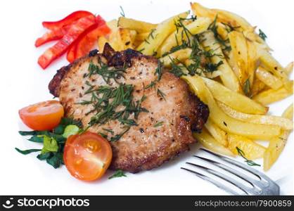 Grilled pork steak on white plate.