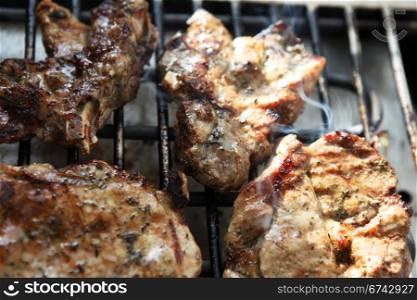 Grilled pork steaks on the grill