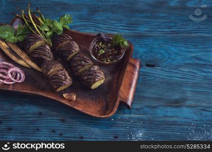 Grilled potato at plate. Grilled potato on a blue wooden background