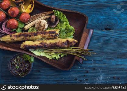 Grilled potato kebab. Grilled potato kebab on a blue wooden background