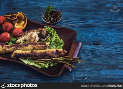Grilled potato kebab on a blue wooden background. Grilled potato kebab