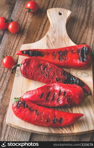 Grilled red peppers on the wooden board