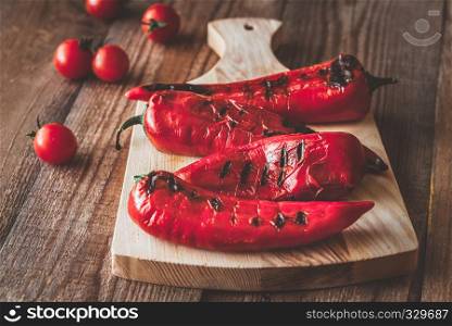 Grilled red peppers on the wooden board