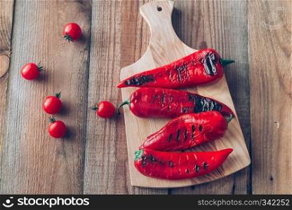 Grilled red peppers on the wooden board