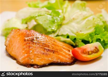 grilled salmon and fresh vegetable ( tomato and lettuce )