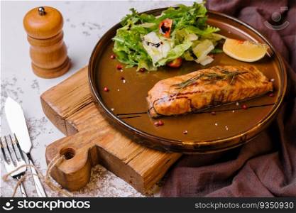 Grilled salmon and vegetables on plate