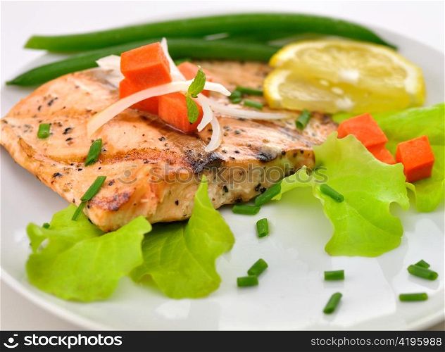 grilled salmon fillet with vegetables and lemon