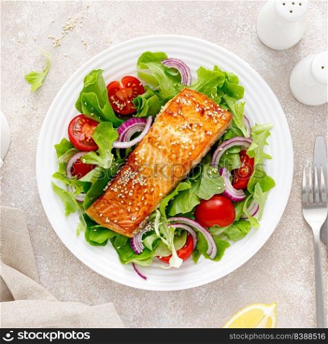 Grilled salmon fish fillet and fresh vegetable salad with tomato, red onion and lettuce. Banner